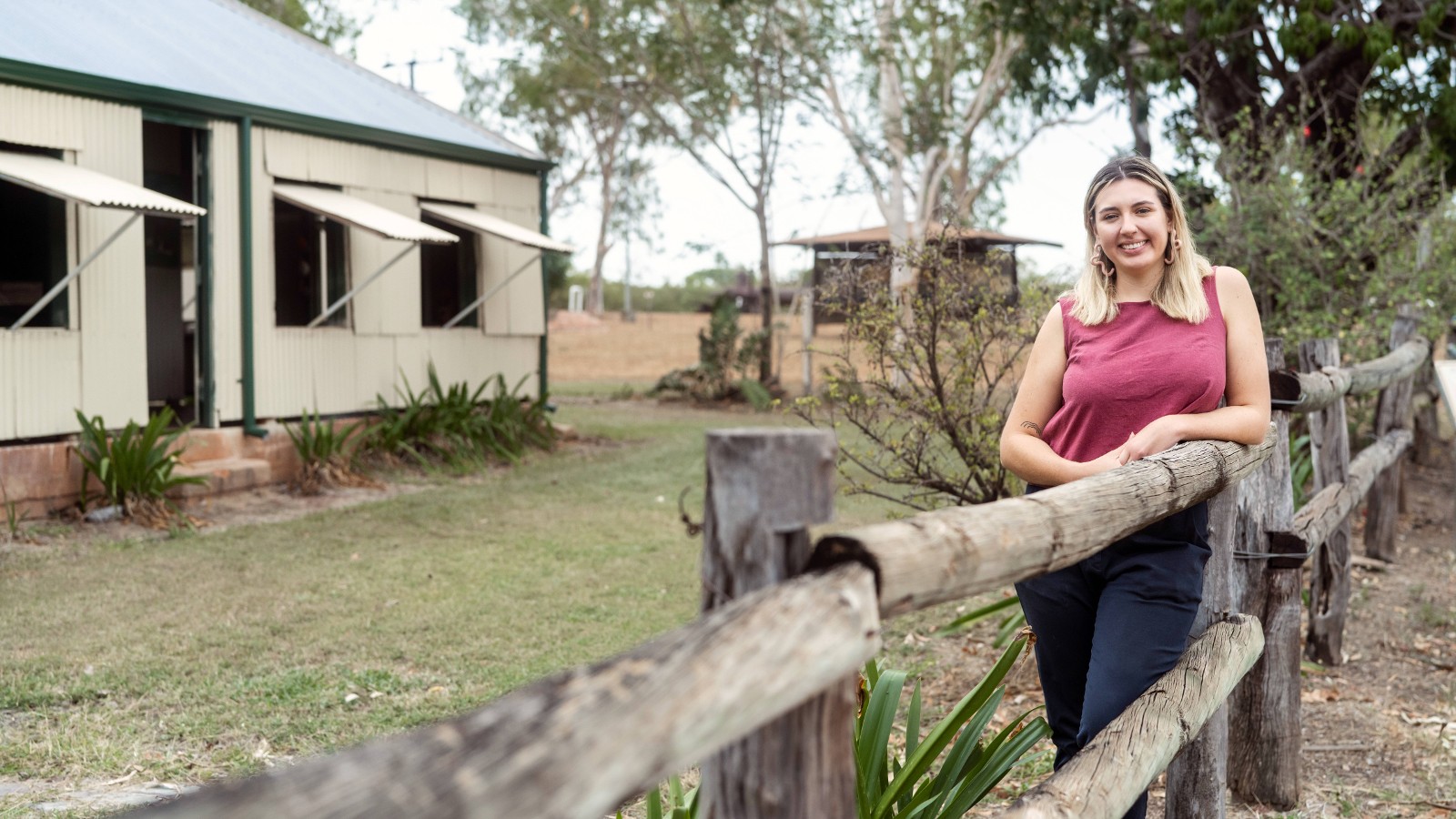 Maggie Coggan leaning on a fence