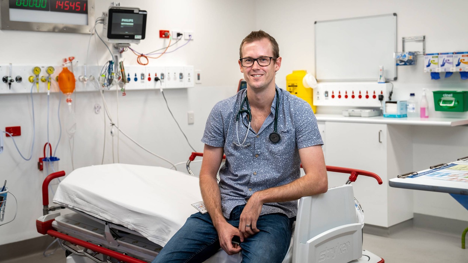 Doctor sitting on hospital stretcher