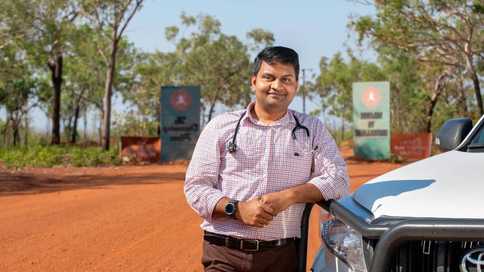 Doctor leaning on a car